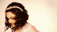 a woman with a headband on her head looks down at something