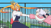 two anime girls are standing next to each other on a balcony