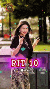 a woman in a black shirt is standing in front of a sign that says rit 10