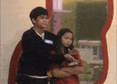 a boy and a girl are standing next to each other and the girl has a shirt that says lulette