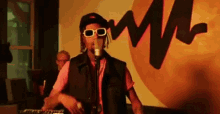 a man is singing into a microphone while playing a keyboard .