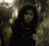 a woman wearing a blue and yellow jacket has a patch on her jacket that says ' eagle ' on it