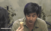 a man is holding an ice cream cone with the hashtag #pbbadultrealtalk