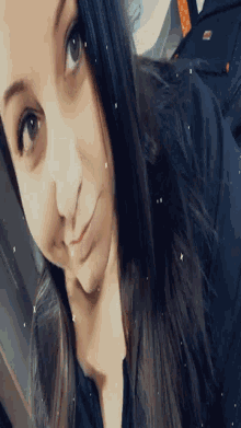 a close up of a woman taking a selfie with her eyes closed