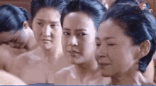 a group of women are standing next to each other without shirts on