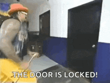 a man in a cowboy hat and sunglasses is standing in a hallway holding a key .