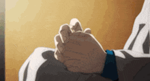 a person is holding another person 's hand in their lap while sitting down .