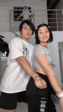 a man and a woman are posing for a tiktok