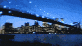 a blurry picture of a bridge over a body of water with a city in the background