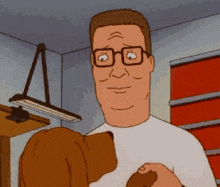 a man with glasses is holding a dog in his arms