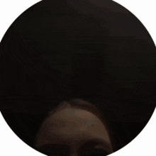 a close up of a person 's face in a circle .