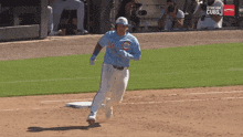 a baseball player wearing a blue cubs jersey