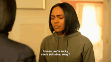 a woman in a green hoodie says anissa we 're lucky she 's still alive okay ?