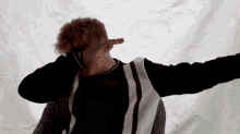 a man with his arms outstretched is covering his face