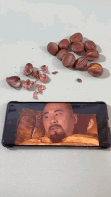 a man with a beard is shown on a cell phone