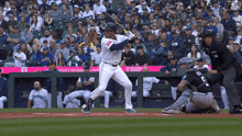 a baseball player swings his bat at a pitch in front of a banner that says america 's largest network