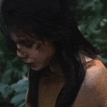 a woman with a bruise on her face is wearing a tan sweater