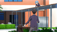 a man and a girl are walking down a sidewalk in front of a building