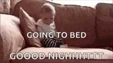 a baby is sitting on a couch with the words `` going to bed '' .