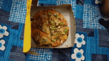 a pizza in a box with a yellow label that says ' your ' on it
