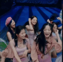 a group of women are dancing in a bowling alley .