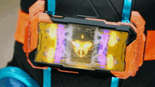 a person is wearing a purple and orange item that looks like a phone