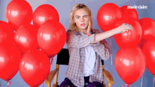 Pop A Balloon Cara Delevingne GIF - Pop A Balloon Cara Delevingne Marie Claire GIFs