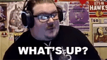 a man wearing headphones and glasses is asking a question .