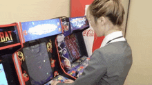a woman playing a video game with a sign that says nfl on it