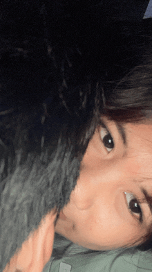 a close up of a woman 's face with a man 's face behind her