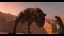 a dinosaur is standing in the desert with a sunset behind it