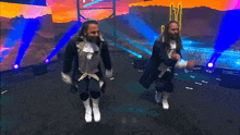 two men are jumping in the air on a stage with a lightning bolt behind them