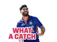 a man in a blue shirt with the words " what a catch " on it