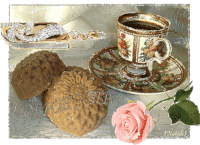 a cup of coffee sits on a saucer next to some cookies and a rose