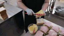 a person is making a sandwich with the words made in animotica behind them