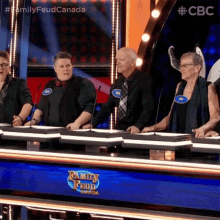 a group of people are playing a game called family feud .