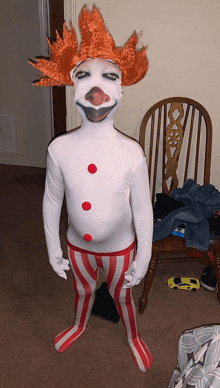 a person dressed as a clown with a red wig and striped pants