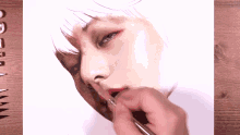 a person is painting a woman 's face with a brush