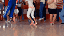 a group of people are dancing in a gym