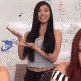 a woman stands in front of a white board that says " uence "