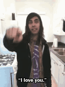 a man in a kitchen with the words " i love you " written on the bottom