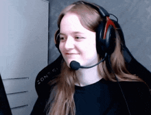 a woman wearing headphones and a microphone has zon-51 written on her seat