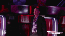 a man in a suit is standing in front of a podium on a stage .