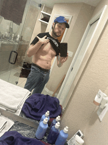 a man is taking a picture of himself in the bathroom mirror