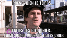 a man wearing a hat with the words prenez bien le temps