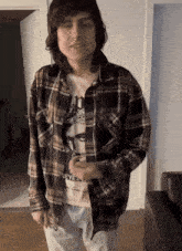 a man wearing a plaid shirt and a shirt that says r.e.y.e.a.r.