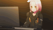 a girl with pink hair is sitting in front of a laptop with the letter k on her jacket