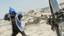 a person wearing a blue cape is chained to a pole