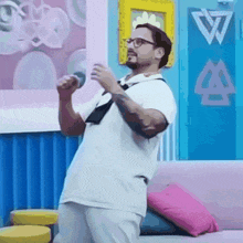 a man singing into a microphone in front of a wall with the letter w on it