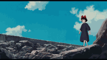a girl with a red bow on her head is standing on a rocky hill